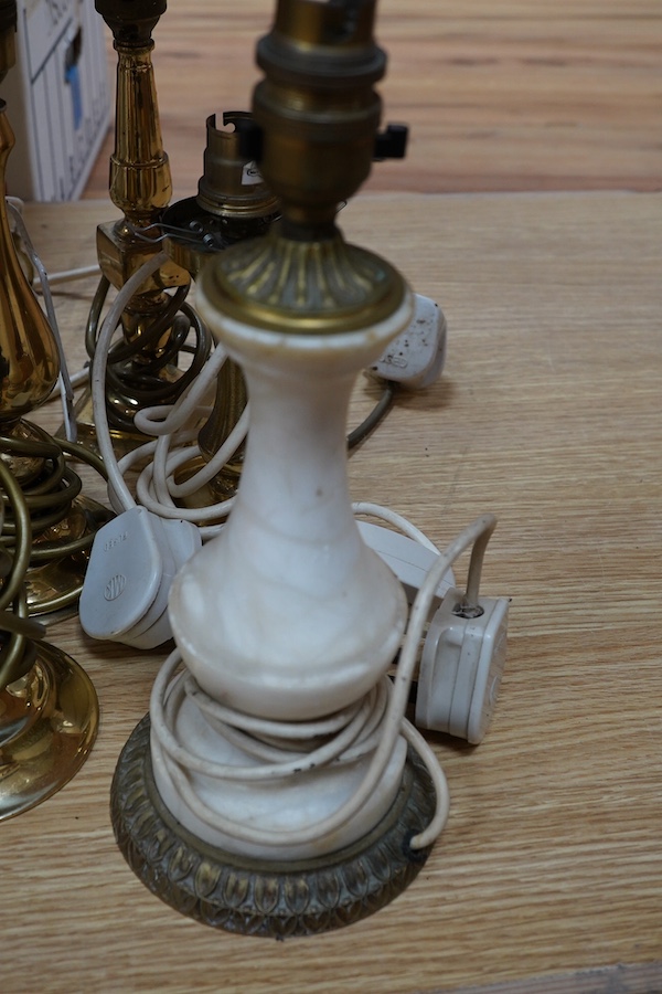 A figurative gilt metal table lamp, five brass table lamps and an alabaster lamp, tallest 35cm high. Condition - one poor, the others fair to good